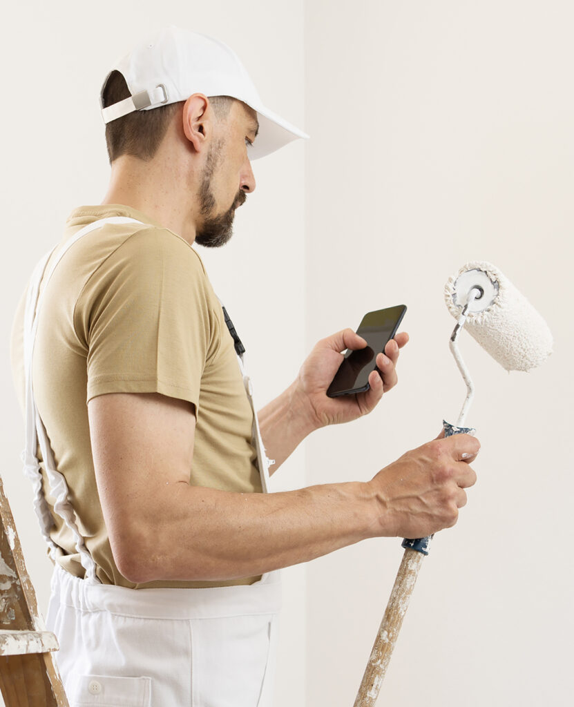 Room Service - Content Room Service - Content 100% 10 D27 Man with a beard wearing a white baseball hat and white overalls holding a black smartphone and a long-handled paint roller. To enable screen reader support, press ⌘+Option+Z To learn about keyboard shortcuts, press ⌘slash Man with a beard wearing a white baseball hat and white overalls holding a black smartphone and a long-handled paint roller. Turn on screen reader support